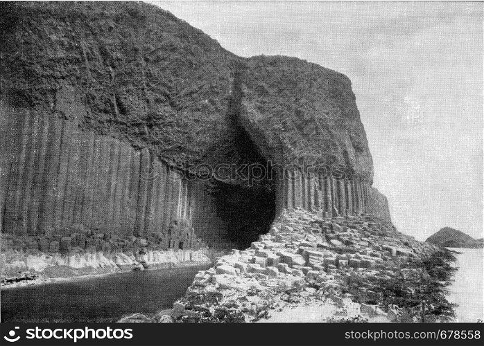 Columns of basalt at the entrance gate of Fingal Cave, Scottish Staffa Island, vintage engraved illustration. From the Universe and Humanity, 1910.