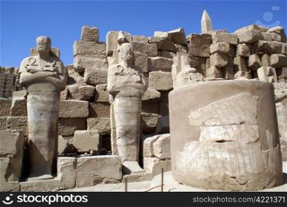 Columns, statues and obelisk in Karnak temple in Luxor, Egypt
