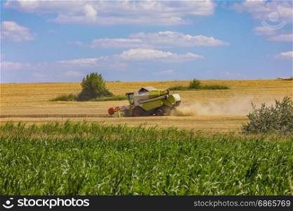 Combine harvester in action on wheat field. Palouse harvest season.