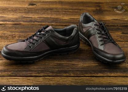 combined man&rsquo;s shoes on wooden background