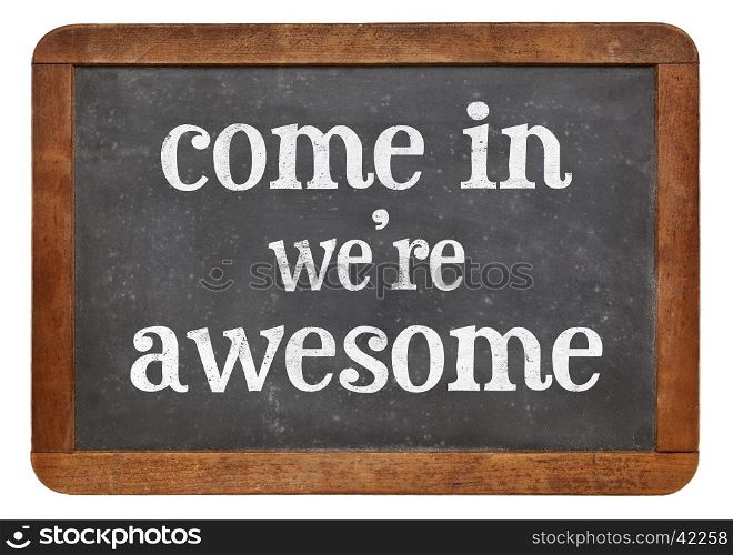 Come in. We are awesome. Invitation sign - white chalk text on a vintage slate blackboard