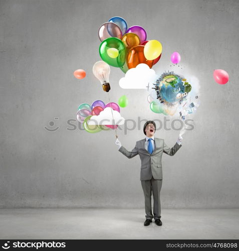 Comedian man with color balloons. Young funny man in hat with balloons presenting celebration concept. Elements of this image are furnished by NASA