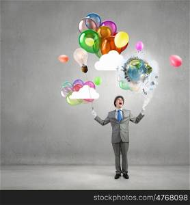 Comedian man with color balloons. Young funny man in hat with balloons presenting celebration concept. Elements of this image are furnished by NASA