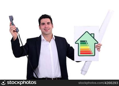 commercial agent holding an energy consumption label and a phone