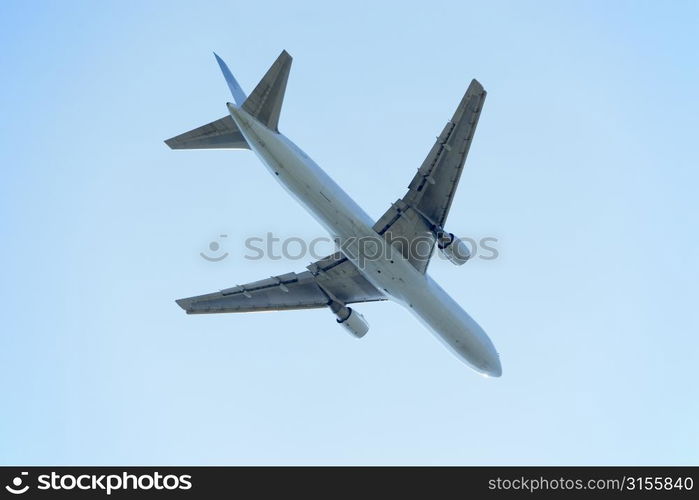 Commercial Airplane Flying Against A Blue Sky