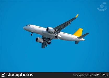 Commercial airplane flying high in clear blue sky. Commercial airplane flying