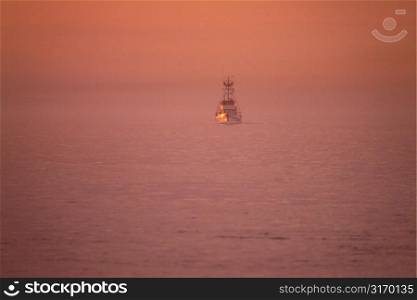 Commercial Fishing Boat In The Bay At Sunset