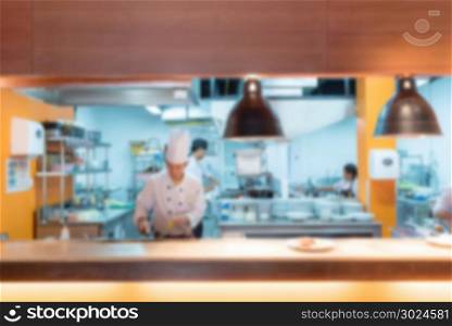 Commercial Kitchen Blurred Background with chef cooking
