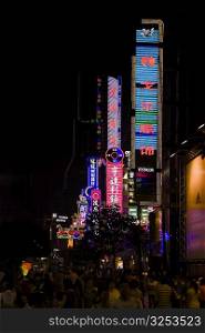 Commercial signs lit up at night, Nanjing Road, Shanghai, China