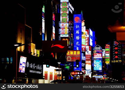 Commercial signs lit up at night, Nanjing Road, Shanghai, China