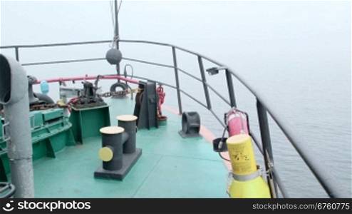 Commercial vessel prow in the misty Sea of Azov