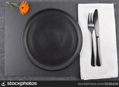 Common marigold and table setting on slate