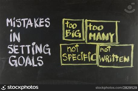 common mistakes in setting goals too many, too big, not specific, not written - concept presented with sticky notes and white chalk handwriting on blackboard