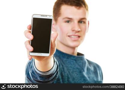 Communication and advertisement. Happy young man showing cell phone smartphone black blank screen isolated on white