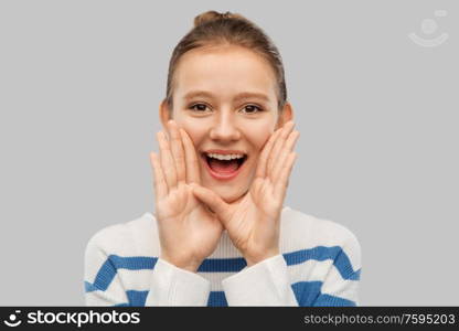 communication and people concept - happy teenage girl calling someone over grey background. happy teenage girl calling someone