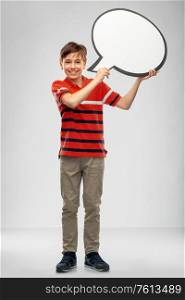 communication and people concept - smiling boy holding blank speech bubble over grey background. boy holding speech bubble