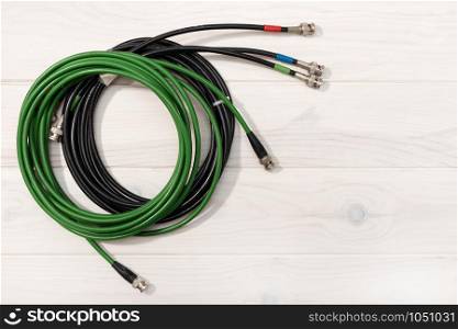 Communication background. Pro video cables on white wooden table. Copy space. Top view
