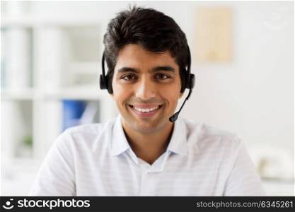 communication, business, people and technology concept - businessman or helpline operator in headset at office. businessman in headset at office