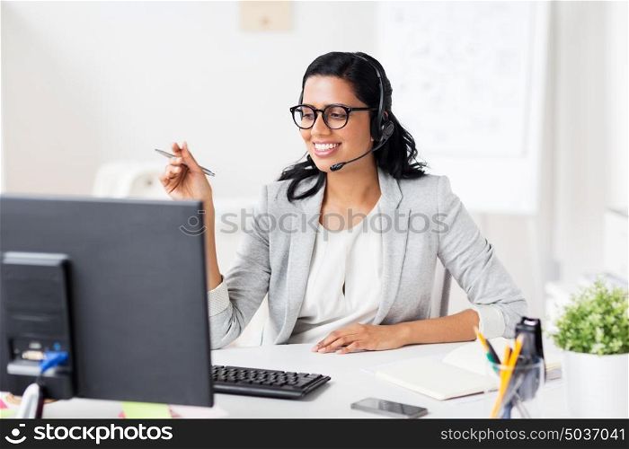 communication, business, people and technology concept - smiling businesswoman or helpline operator with headset and computer at office. businesswoman with headset and computer at office