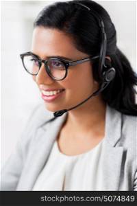 communication, business, people and technology concept - smiling businesswoman or helpline operator with headset talking at office. businesswoman with headset talking at office