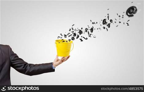 Communication concept. Close up of hand holding yellow bucket with letters