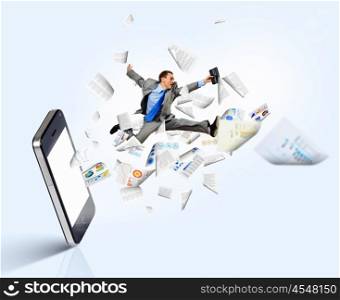Communication concept. Image of businessman jumping out of mobile phone