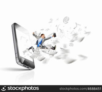 Communication concept. Image of businessman jumping out of mobile phone