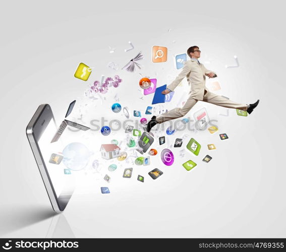 Communication concept. Image of businessman jumping out of mobile phone