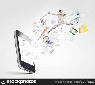 Communication concept. Image of businessman jumping out of mobile phone