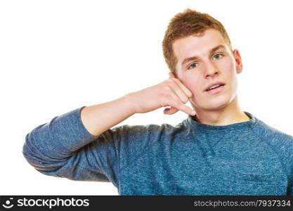 Communication concept. Young man making call me gesture. Blonde teen boy with phone hand sign isolated on white