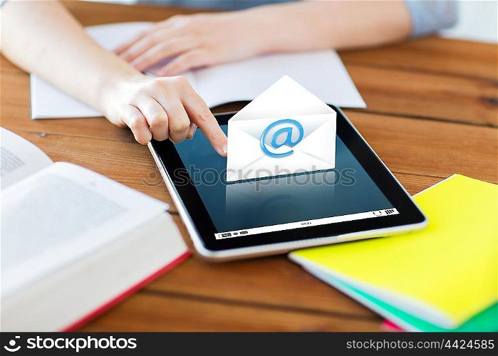 communication, education, technology and internet concept - close up of student woman with e-mail icon on tablet pc computer and notebook at home