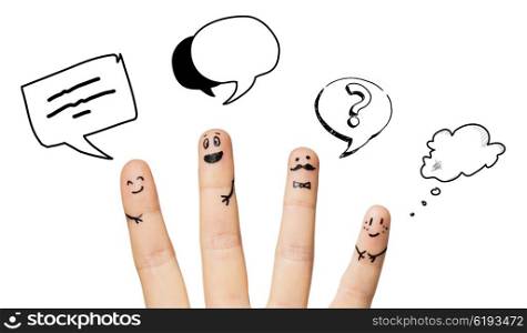 communication, family, people and body parts concept - close up of four fingers with smiley faces over text clouds