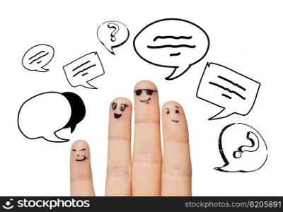 communication, family, people and body parts concept - close up of four fingers with different facial expressions and text clouds