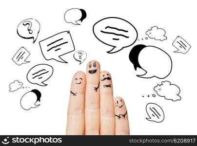 communication, family, people and body parts concept - close up of four fingers with different facial expressions and text clouds