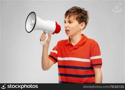 communication, feminism and rights concept - angry boy speaking to megaphone over grey background. angry boy speaking to megaphone