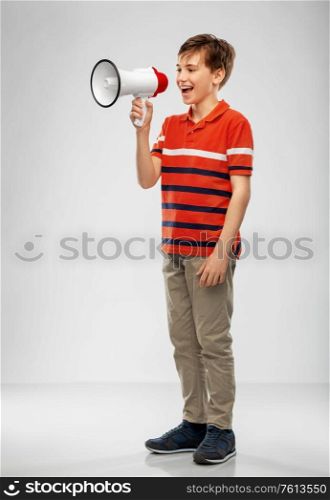 communication, feminism and rights concept - boy speaking to megaphone over grey background. boy speaking to megaphone