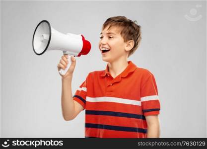 communication, feminism and rights concept - boy speaking to megaphone over grey background. boy speaking to megaphone