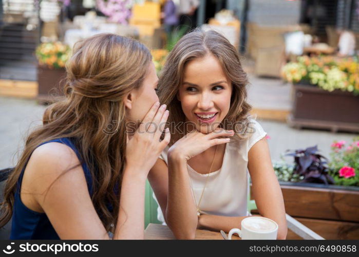 communication, friendship and people concept - happy young women drinking coffee at outdoor cafe. happy young women drinking coffee at outdoor cafe. happy young women drinking coffee at outdoor cafe