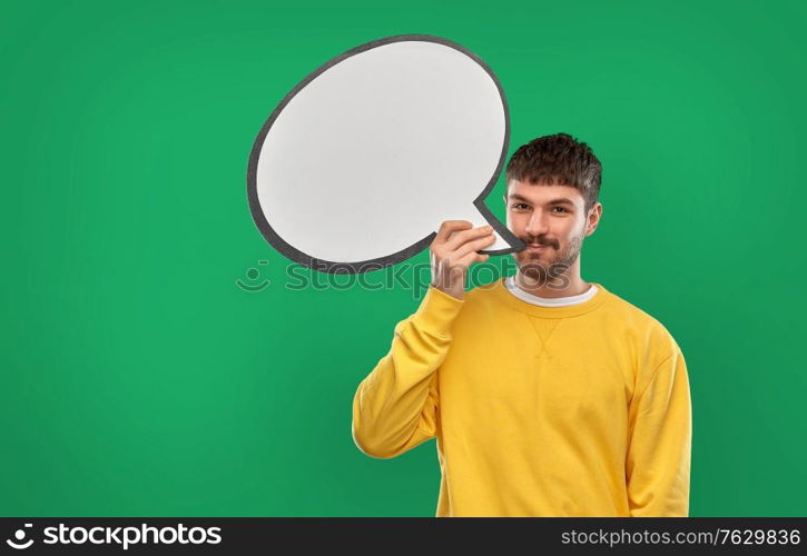 communication, mass media and people concept - happy smiling young man with speech bubble over emerald green background. happy man with speech bubble over green background