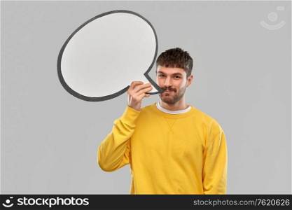 communication, photo booth and people concept - happy smiling young man with speech bubble over grey background. happy man with speech bubble over grey background