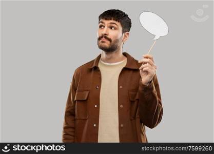 communication, photo booth and people concept - young man with speech bubble over grey background. young man with speech bubble over grey background