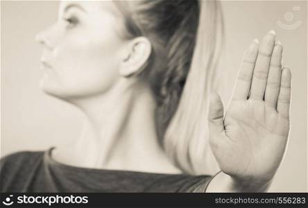 Communication psychology negative defensive concept. Assertive woman making stop gesture. Strong blonde lady showing hold sign.. Assertive woman making stop gesture.
