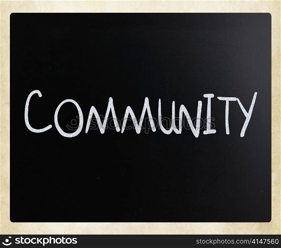 ""Community" handwritten with white chalk on a blackboard"