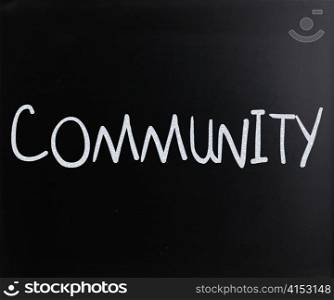 ""Community" handwritten with white chalk on a blackboard"