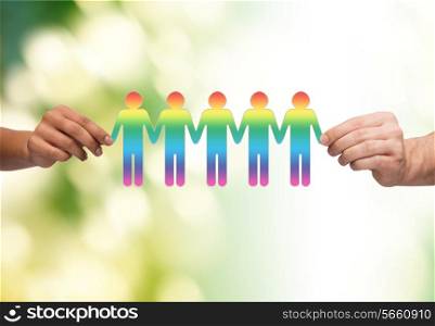 community, unity and teamwork concept - close up of multiracial couple hands holding paper chain gay people cutout over green background