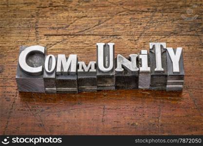 community word in mixed vintage metal type printing blocks over grunge wood