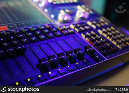 Compact lighting control console for music shows and concerts. Selective focus.
