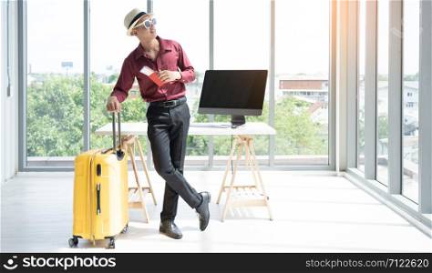 Company employees prepare for weekend travel.Young asian businessman preparing for vacation in the office.