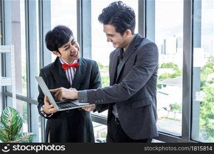 Company executive Young Asian businessman and coaching personal secretary assistant Homosexual businessman LGBT partners while working together with laptop computer and strategy in business in office