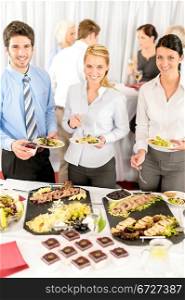 Company meeting catering smiling business people eat buffet appetizers